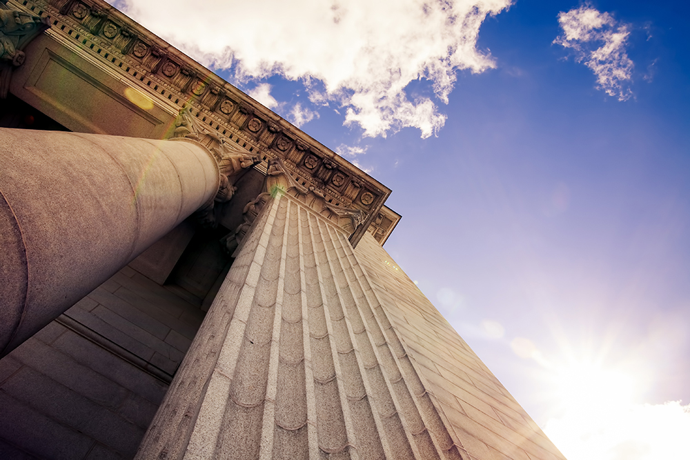 Upward view of a court house with impressive pillars